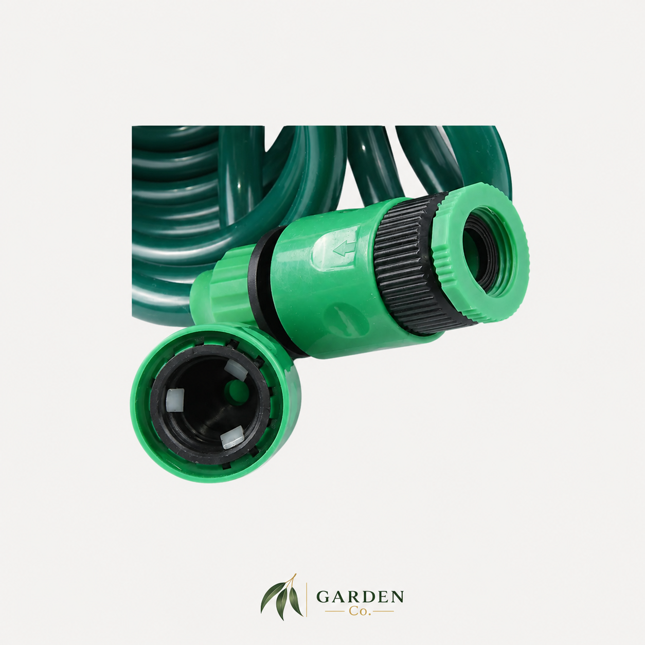 A green garden hose with a green and black adjustable connector, shown on a light gray background with the Garden Co logo at the bottom.