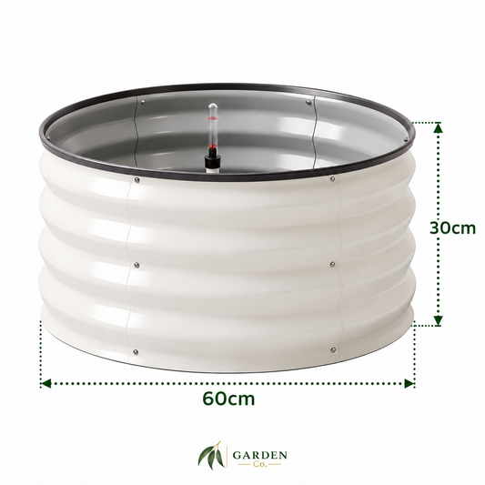 A cylindrical raised garden bed with a white ribbed metal body, a black top rim, and a clear plastic thermometer in the center. Green dotted measurement lines indicate dimensions of 60cm in width and 30cm in height, with the Garden Co logo at the bottom.