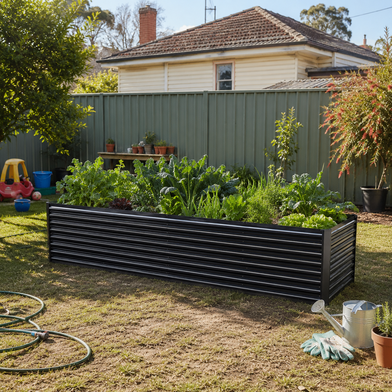2 in 1 Galvinised Garden Bed in a backyard with plants and a house in the background.