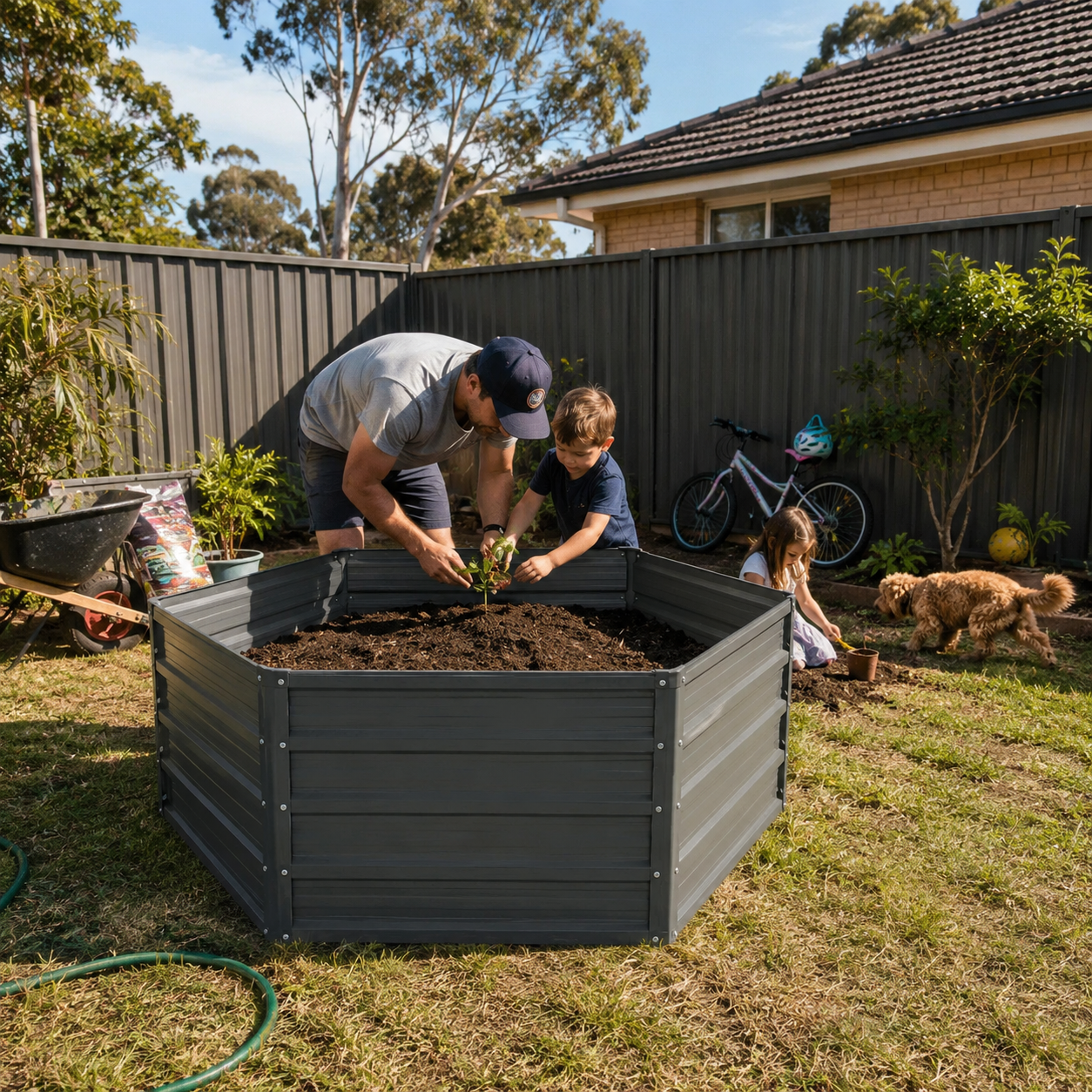 Hexagonal Steel Raised  Garden Bed with man and child planting in a raised garden bed with a dog and bicycle in the background.
