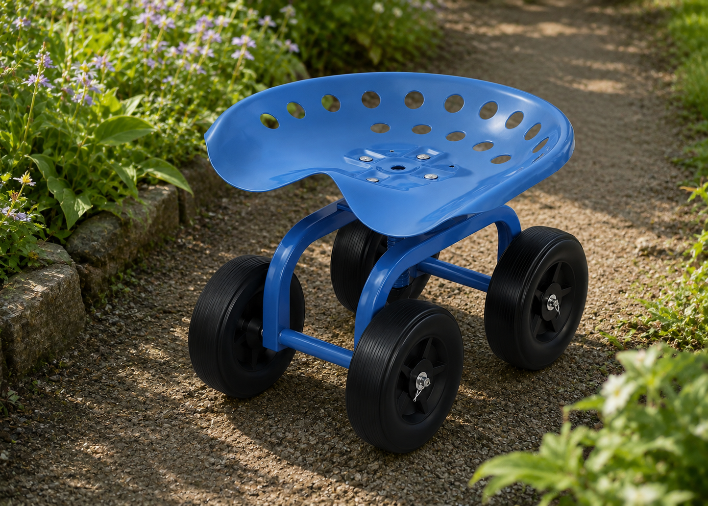 A blue garden wheel chair with a perforated seat and four black wheels, positioned on a gravel garden path surrounded by green plants.