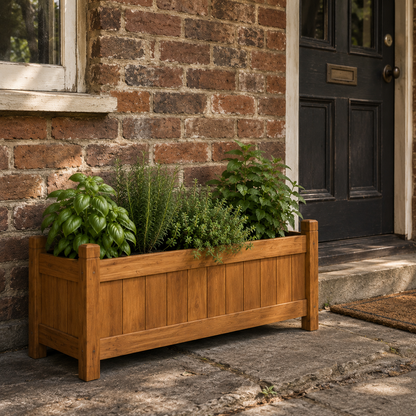 Wooden raised garden bed planter with plants against a brick wall and door