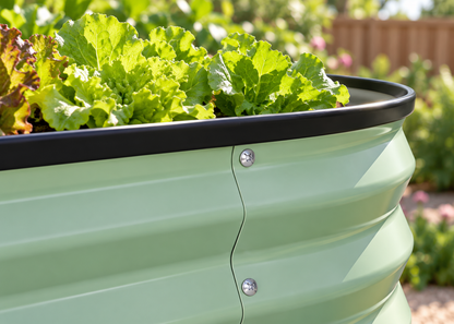 Close-up of the black rounded rim and screwed panel join on the green corrugated steel garden bed.
