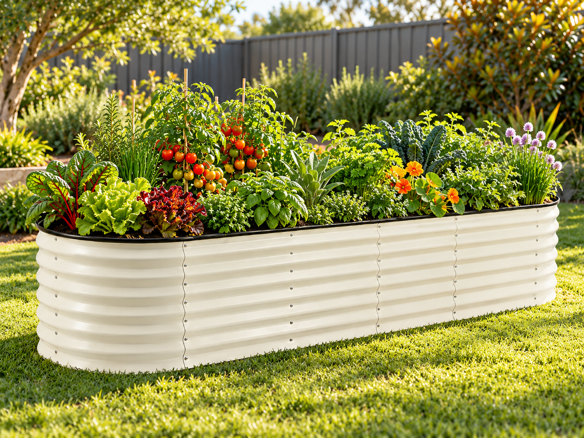 Medium Raised Oval Garden Bed White – On a backyard lawn, planted with tomatoes, leafy greens, herbs and flowers.